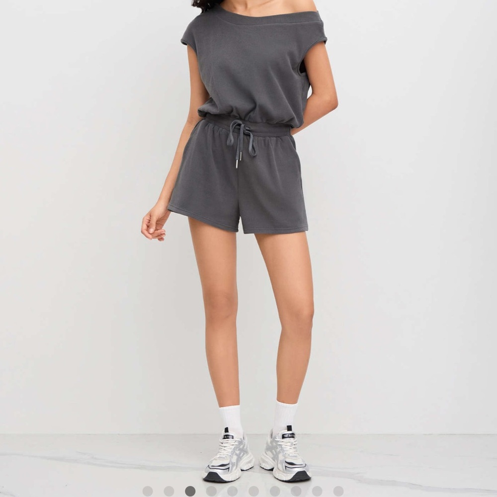 Asymmetrical tie waist short romper.